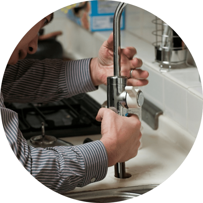 Plombier installant un robinet